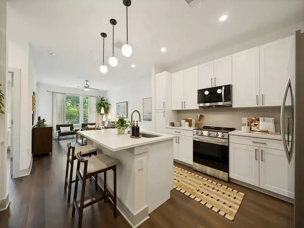 Austin tx kitchen island 1440x1080 at Groves South Congress apartments in Austin TX